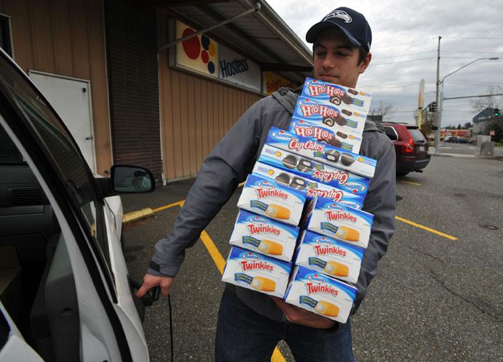 Andy Wagar loads Twinkies, Ho-Hos and cupcakes into a van outside the Wonder Bakery Thrift Shop in Bellingham, Washington in preparation for the end of the world this Friday. (Philip A. Dwyer/Bellingham Herald/MCT)