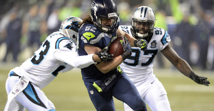 Seattle Seahawks tight end Luke Willson (82) heads to the end zone with a 25-yard touchdown past the Carolina Panthers Melvin White (23) and Mario Addison (97) in the second half in NFC Divisional Playoff action at CenturyLink Field in Seattle on Saturday, Jan. 10, 2015. The Seahaws won, 31-17. (David T. Foster, III/Charlotte Observer/TNS)