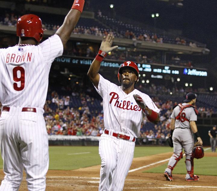 The Philadelphia Phillies Jimmy Rollins high-fives Domonic Brown (9) after scoring in the third inning against the St. Louis Cardinals on Friday, Aug. 22, 2014, at Citizens Bank Park in Philadelphia. (Ron Cortes/Philadelphia Inquirer/MCT)