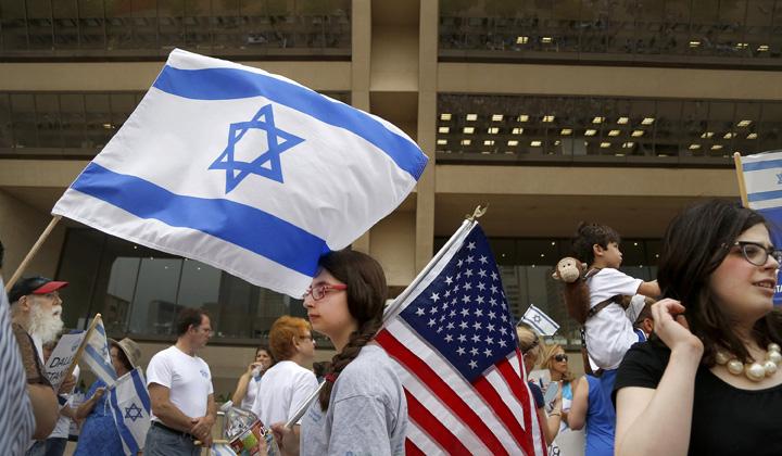 Lily Goldberg, 13, holds a U.S. flag during a rally in support of Israel in front of City Hall in Dallas on Wednesday, July 30, 2014. (Brad Loper/Dallas Morning News/MCT)