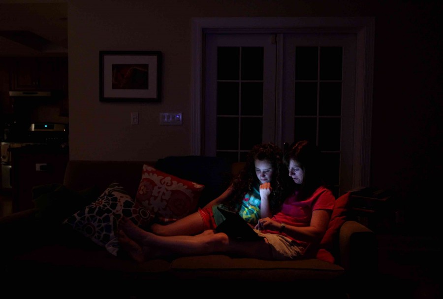 Sheri Jacobs and her daughter, Jillian, 10, use an iPad as they relax on the couch at their home in Deerfield, Illinois, on June 29, 2012. Some doctors worry about light from electronic devices having a detrimental effect on sleep. (Chris Sweda/Chicago Tribune/MCT)