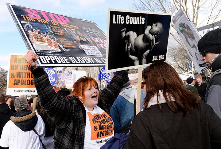 Pro-choice and pro-life activists confront each other during the March For Life in front of the U.S. Supreme Court in Washington, D.C., on Thursday, Jan. 22, 2015. Tens of thousands of Americans who oppose abortion are in Washington for the annual March for Life, marking the 42nd anniversary of the Supreme Court's Roe v. Wade decision. (Olivier Douliery/Abaca Press/TNS)