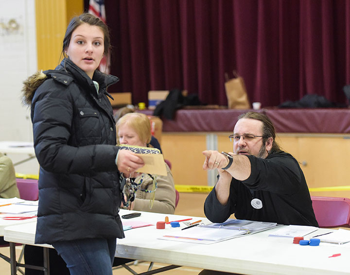 A New Hampshire voter checked in at a polling station in Manchester, N.H., on Tuesday, Feb. 9, 2016, as both Republicans and Democrats registered votes in their respective presidential primaries. (Bao Dandan/Xinhua/Sipa USA/TNS)