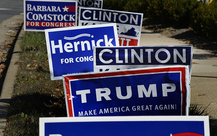 A Republican Presidential candidate Donald Trump campaign sign and a Democartic Presidential candidate Hillary Clinton sign are posted on a road 10 days away from the 2016 presidential election, on Oct. 28, 2016 in Mclean, Va. (Olivier Douliery/Abaca Press/TNS)