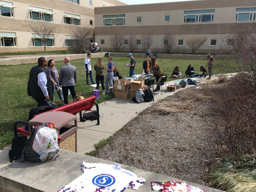 Harriton students tie-dye Adam Spector Walk T-shirts in the courtyard, April 12, 2018.