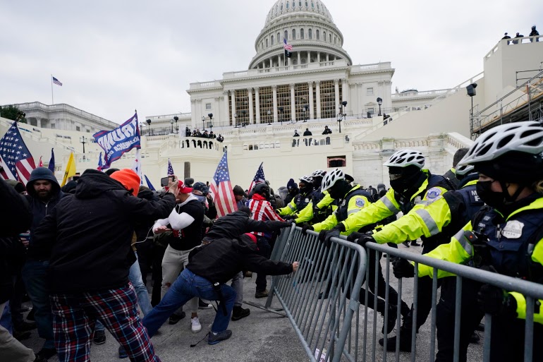 Trump supporters try to break through a police barrier, Wednesday, Jan. 6, 2021, at the Capitol in Washington. As Congress prepares to affirm President-elect Joe Bidens victory, thousands of people have gathered to show their support for President Donald Trump and his claims of election fraud. (AP Photo/Julio Cortez)