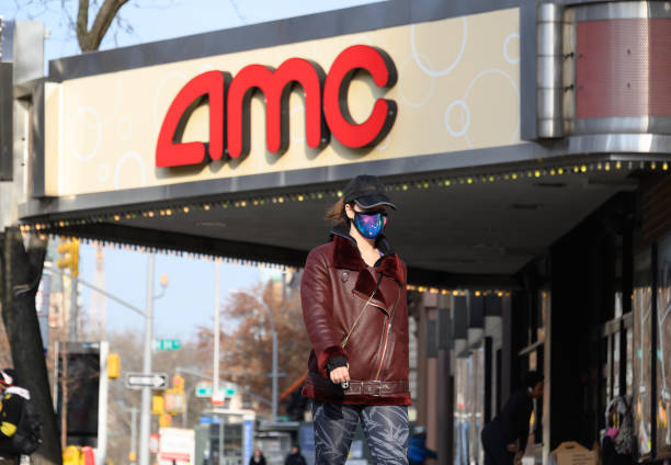 NEW YORK, NEW YORK - DECEMBER 11: A person wears a face mask outside AMC 84th Street 6 movie theater on the Upper West Side as the city continues the re-opening efforts following restrictions imposed to slow the spread of coronavirus on December 11, 2020 in New York City. The pandemic has caused long-term repercussions throughout the tourism and entertainment industries, including temporary and permanent closures of historic and iconic venues, costing the city and businesses billions in revenue. (Photo by Noam Galai/Getty Images)
