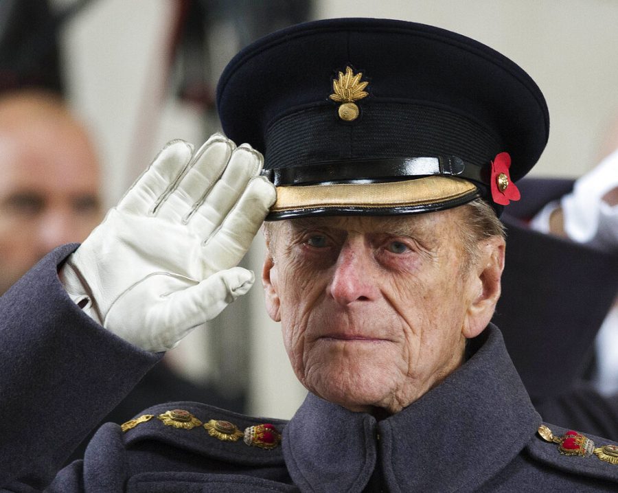 FILE - In this file photo dated Monday, Nov. 11, 2013, Britains Prince Philip salutes during a special Armistice Day ceremony under the Menin Gate in Ypres, Belgium. The Duke of Edinburgh attended a special Armistice Day ceremony on Monday to oversee the handover of 70 sandbags of soil from Flanders fields. The sandbags, collected by Belgian and British schoolchildren from Commonwealth cemeteries in Belgium, were handed over to the Kings Troop Royal Horse Artillery and will be taken to London and placed in the Flanders Fields Memorial Garden at the Wellington Barracks. When Elizabeth became queen at the age of 25 in 1952, Philip gave up his naval career and dedicated himself to supporting her and the monarchy.  Prince Philip who died Friday April 9, 2021, aged 99, lived through a tumultuous century of war and upheavals. (AP Photo/Paul Edwards, FILE)