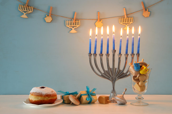 image+of+jewish+holiday+Hanukkah+background+with+traditional+spinnig+top%2C+menorah+%28traditional+candelabra%29+and+burning+candles